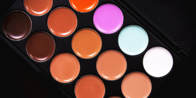 Palette concealer and correctors. Make-up base. Isolated on black background